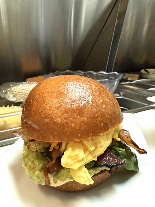 Bacon, egg and avocado sandwich on a brioche bun