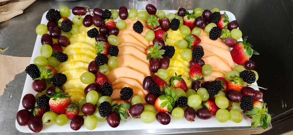 Fresh fruit platter with melon, pineapple, grapes and berries