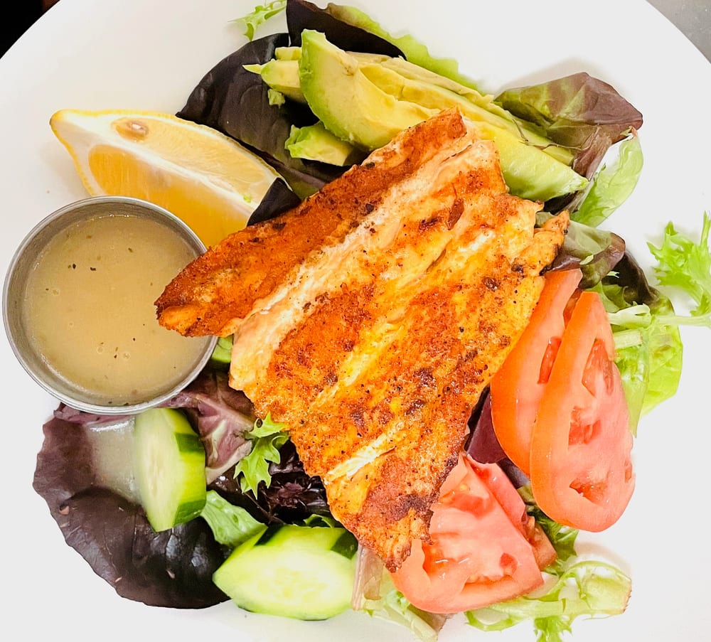 Blackened salmon salad with tomato, cucumber and avocado
